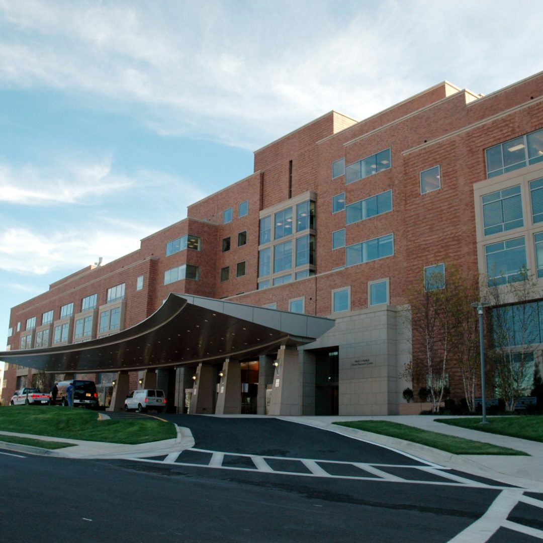 Photo by National Cancer Institute brown concrete building under blue sky during daytime